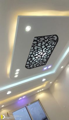 the ceiling in this room is decorated with white and black designs, along with recessed lighting