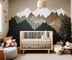 a baby's room with mountains painted on the wall and a white crib