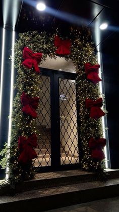 a door decorated with red bows and lights