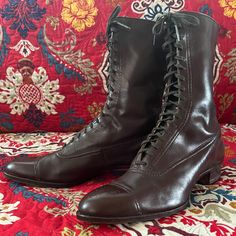 Edwardian lace-up boots in brown leather with charming fleur-de-lis perforation details on the toe caps. Very wearable and in amazing condition, especially considering they are at least 90 years old or older. Soles and heels are repaired and in very good condition. Insole is 10.25" long and 3" across ball of foot. Heel is 1.25" tall. Boot height is 7.75". Edwardian Boots, Antique Shoes, Granny Boots, Tall Boot, Dark Brown Leather, Early 1900s, Boot Shoes Women, Lace Up Boots, 20 Cm