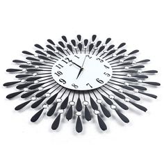 a clock made out of forks and spoons on a white surface with black numbers