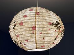 a large paper lantern hanging from a ceiling