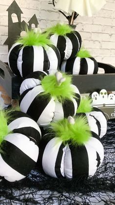 black and white striped pumpkins with green feathers