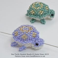 two beaded turtle figurines sitting on top of each other