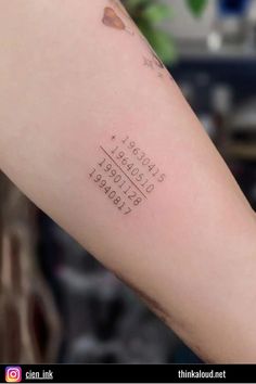 a person with a tattoo on their arm that has words and numbers written on it