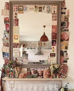 a fireplace mantle covered in lots of different types of decorations and pictures under a large mirror