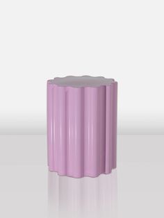 a purple vase sitting on top of a white table