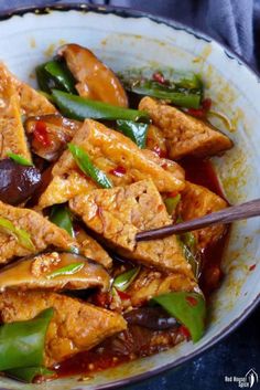 chinese tofu with peppers and green beans in a white bowl