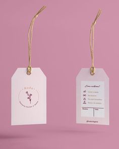 two tags hanging from twine on pink background