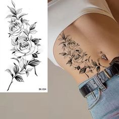 a woman's stomach with flowers and leaves tattoo on the left side of her stomach