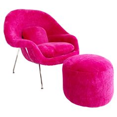 the pink chair and ottoman are next to each other