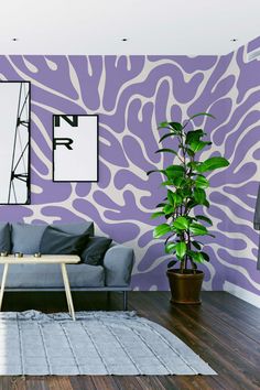 a living room with purple and white wallpaper