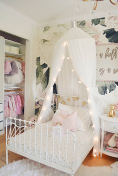 a white bed sitting in a bedroom under a canopy