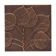 a brown tile with leaves on it