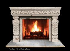 a fireplace with a fire burning in it's mantle and an ornate design on the top