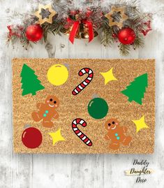 a christmas door mat with gingerbreads and candy on it