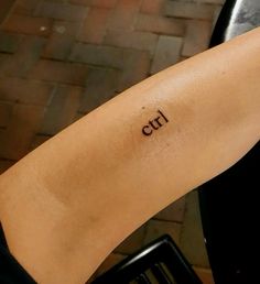 a woman's arm with the word girl written on it, and an arrow in cursive font