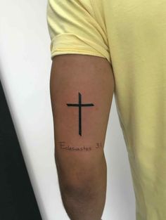 a man with a cross tattoo on his arm