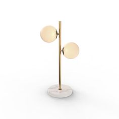 a white and gold floor lamp with two balls on the base, one light is turned off