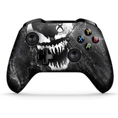 a black and white game controller with an image of a monster's face on it