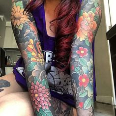 a woman with tattoos on her arms and legs