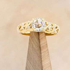 a yellow gold engagement ring with an old cut diamond