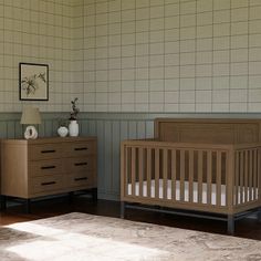 a baby's room with two cribs, dresser and rug on the floor