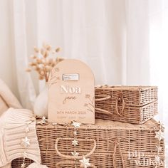 three wicker baskets stacked on top of each other with personalized tags attached to them