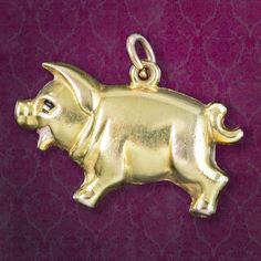 This sweet little pig charm pendant is modelled in smooth 9ct gold with enamel detailing around his eyes and smiling mouth. It was made by Georg Jensen Ltd in the 20th Century and bears their mark on the side along with London hallmarks.  It's a wonderful little pendant, very collectable and would look perfect on a gold chain or as a bracelet charm.  WEIGHT: 1.9 grams MEASURES: Height 14mm (19mm inc. loop) x Width 23mm x Depth 6mm METAL: 9ct Gold (Stamped) AGE: Circa 1950 - 1970 MARKS: London ha Pig Bracelet, Flying Pig Earrings, Yellow Gold Coin-shaped Charms Jewelry, Pig Necklace Jewelry, Vintage Yellow Gold Dangling Charms, Georg Jensen, Little Pigs, Makers Mark, Gold Chains