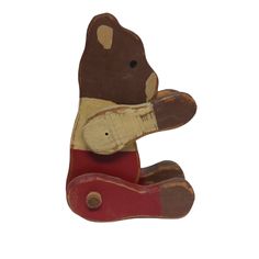 a wooden bear sitting on its hind legs