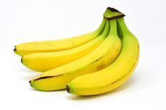 three bunches of bananas sitting next to each other on a white surface with no one around them