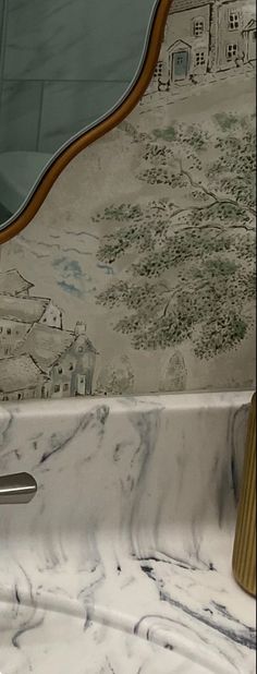 a marble sink with a mirror above it and wallpaper on the walls behind it