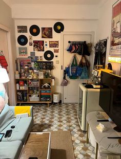 a living room filled with furniture and lots of records