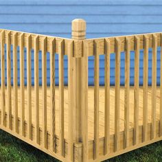 a wooden crib sitting in the grass next to a blue wall and green grass