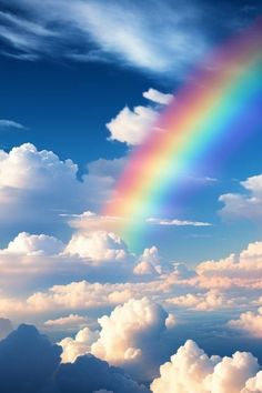 a rainbow is in the sky above some clouds