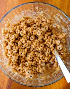 a glass bowl filled with cereal on top of a wooden table