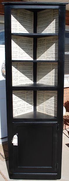 a black bookcase sitting on top of a sidewalk