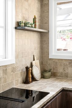 a kitchen counter top under a window next to a sink