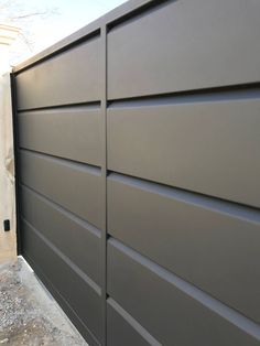 the side of a garage door that is painted gray