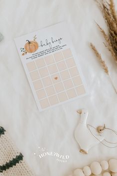 an orange themed baby shower game is displayed on a blanket next to other toys and decorations