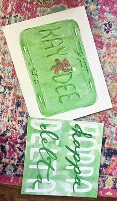 two green trays sitting on top of a rug next to each other with the words happy new year written on them