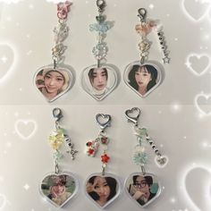 four heart shaped key chains with pictures on them