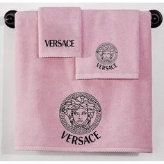 two pink towels with versa logos on them