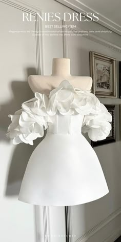 a white dress with flowers on the front