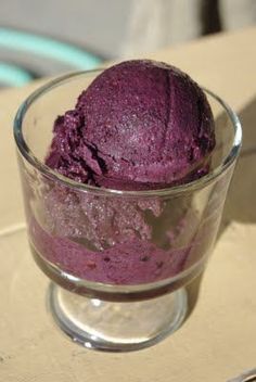 a glass bowl filled with purple ice cream