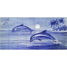 two dolphins swimming in the ocean with palm trees