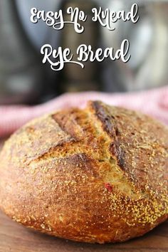 a loaf of bread sitting on top of a wooden cutting board with the words easy no - knead rye bread