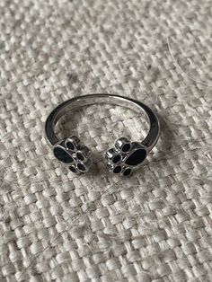 a silver ring with two paw prints on it