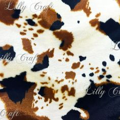 an animal print fabric with brown and white spots on the top, in various colors