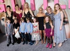 a group of people standing next to each other in front of a sign that says girls